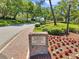 Clubhouse entrance with manicured landscaping, showcasing a welcoming environment for guest registration at 36750 Us 19 N # 2763, Palm Harbor, FL 34684