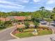 Well-maintained entrance to the community with landscaping, a sign, and a building at 36750 Us 19 N # 2763, Palm Harbor, FL 34684
