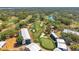 Aerial view of a green golf course surrounded by white tents and water, with trees and sand traps at 36750 Us 19 N # 2763, Palm Harbor, FL 34684