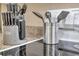 Close up of a kitchen counter with a knife block, cooking utensils, and a glass nearby at 36750 Us 19 N # 2763, Palm Harbor, FL 34684