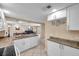 Open kitchen with granite counters, white cabinets, and access to the living and dining areas at 36750 Us 19 N # 2763, Palm Harbor, FL 34684