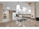 Bright kitchen featuring stainless steel sink, granite countertops, white appliances, and modern pendant lighting at 36750 Us 19 N # 2763, Palm Harbor, FL 34684