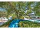 Scenic view of community pool featuring lush greenery and waterslide offering a tranquil retreat at 36750 Us 19 N # 2763, Palm Harbor, FL 34684