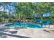 Community pool featuring waterslides and lush greenery offering a recreational retreat for residents at 36750 Us 19 N # 2763, Palm Harbor, FL 34684