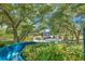 Scenic view of community pool featuring lush greenery and waterslide offering a tranquil retreat at 36750 Us 19 N # 2763, Palm Harbor, FL 34684