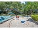 Sandy recreational area with lounge chairs, games, and umbrellas for leisure activities at 36750 Us 19 N # 2763, Palm Harbor, FL 34684