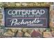 Exterior signage for Copperhead Clubhouse & Golf Shop and Packard's Steakhouse mounted on a stone wall at 36750 Us 19 N # 2763, Palm Harbor, FL 34684