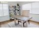 Bright home office featuring a modern desk, stylish chair, open shelving, and natural light from large windows at 4303 Whittner Dr, Land O Lakes, FL 34639