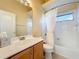 Well-lit bathroom with a single vanity, mirror, and a shower-tub combination with a curtain at 4499 Chase Oaks Dr, Sarasota, FL 34241