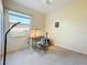Cozy bedroom featuring neutral walls, a ceiling fan, and a window providing natural light at 4499 Chase Oaks Dr, Sarasota, FL 34241