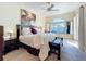 Bright bedroom featuring a large window, ceiling fan, and comfortable king sized bed at 4499 Chase Oaks Dr, Sarasota, FL 34241