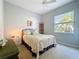 Comfortable bedroom with a queen bed, ceiling fan, and a window for natural light at 4499 Chase Oaks Dr, Sarasota, FL 34241