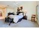 This bedroom features a bed, ceiling fan and a full bath and walk in closet at 4499 Chase Oaks Dr, Sarasota, FL 34241