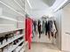Walk-in closet with an organization system for shoes, clothes, and accessories at 4499 Chase Oaks Dr, Sarasota, FL 34241