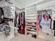 Walk-in closet with an organization system including shelves, hanging rods and shoe rack at 4499 Chase Oaks Dr, Sarasota, FL 34241