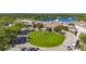 A clubhouse featuring lush green landscaping, flagpole, and parking at 4499 Chase Oaks Dr, Sarasota, FL 34241