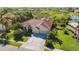 Stunning home featuring lush landscaping, a red tile roof and a spacious driveway leading to a two-car garage at 4499 Chase Oaks Dr, Sarasota, FL 34241