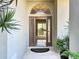 Foyer with an open door leading to a bright living area, showcasing tile flooring and natural light at 4499 Chase Oaks Dr, Sarasota, FL 34241