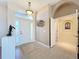 Elegant foyer featuring tile flooring, stylish accents, and an archway that leads to other rooms at 4499 Chase Oaks Dr, Sarasota, FL 34241
