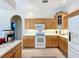 Kitchen features light wood cabinets, white appliances, and a cozy breakfast nook perfect for casual dining at 4499 Chase Oaks Dr, Sarasota, FL 34241