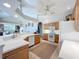 Well-lit kitchen featuring wood cabinets, white appliances, and an open design at 4499 Chase Oaks Dr, Sarasota, FL 34241