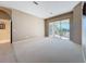 Bright living room featuring neutral carpeting and a sliding glass door leading to the outdoor area at 4499 Chase Oaks Dr, Sarasota, FL 34241