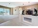 Spacious living room featuring neutral tones, tile flooring, and an adjacent screened-in porch at 4499 Chase Oaks Dr, Sarasota, FL 34241