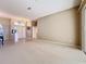 Large living area featuring neutral carpet, a view of the entry way, and ample space at 4499 Chase Oaks Dr, Sarasota, FL 34241