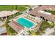 A community swimming pool with hot tub and chairs next to the clubhouse at 4499 Chase Oaks Dr, Sarasota, FL 34241