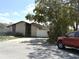 Charming home exterior with a clean driveway, tidy landscaping, and a secure fence, complemented by mature trees at 5006 Aberdeen Ct, Tampa, FL 33624