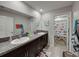 Bright bathroom featuring double sinks, granite countertops, and charming fish-themed shower curtain at 5210 Dandelion St, Apollo Beach, FL 33572
