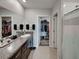 Bathroom featuring dual vanities, granite countertops, and a walk-in closet at 5210 Dandelion St, Apollo Beach, FL 33572