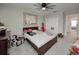 A carpeted bedroom featuring a ceiling fan, picture window, and comfortable furnishings at 5210 Dandelion St, Apollo Beach, FL 33572