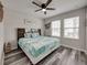 Cozy bedroom with wood-look flooring, natural light, and a decorative headboard at 5210 Dandelion St, Apollo Beach, FL 33572