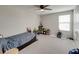 Bright carpeted bedroom includes a ceiling fan, closet, and ample room for play at 5210 Dandelion St, Apollo Beach, FL 33572