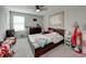 A carpeted bedroom featuring a ceiling fan, picture window, and comfortable furnishings at 5210 Dandelion St, Apollo Beach, FL 33572