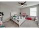 A bedroom featuring butterfly bedding, a ceiling fan, and a bright and playful decor at 5210 Dandelion St, Apollo Beach, FL 33572