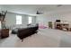 Spacious bonus room features carpet floors, two sofas, a desk, and abundant natural light at 5210 Dandelion St, Apollo Beach, FL 33572