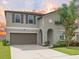 Charming two-story home featuring a well-maintained front yard and a two-car garage at 5210 Dandelion St, Apollo Beach, FL 33572