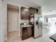 View of the kitchen area, showcasing stainless steel refrigerator and access to the dining room at 5210 Dandelion St, Apollo Beach, FL 33572