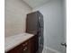 Laundry room featuring a stacked washer and dryer and a wood countertop at 5210 Dandelion St, Apollo Beach, FL 33572
