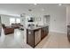 Open-concept view from living room island featuring a kitchen sink with stainless steel dishwasher at 5210 Dandelion St, Apollo Beach, FL 33572