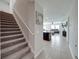 Hallway showcasing the carpeted stairs, tile floors, and living room at 5210 Dandelion St, Apollo Beach, FL 33572