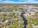 Aerial shot of a waterfront community with bridges and buildings in the distance under a bright sky at 57 Hamilton Heath Dr Dr, Tampa, FL 33604