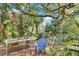 Lush backyard featuring verdant trees and plants, tables and several chairs for seating and relaxing at 57 Hamilton Heath Dr Dr, Tampa, FL 33604