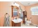 This is a bathroom with a vanity, commode, mirror, and neutral paint at 6418 Austrian Blvd, Punta Gorda, FL 33982