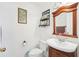Bathroom features a vanity, toilet, and wood-framed mirror at 6418 Austrian Blvd, Punta Gorda, FL 33982