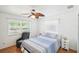 Bedroom features a window, ceiling fan, and comfortable chair at 6418 Austrian Blvd, Punta Gorda, FL 33982
