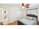 Bright bedroom with wood floors, closet, ceiling fan, and view to the outside at 6418 Austrian Blvd, Punta Gorda, FL 33982