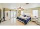 Bedroom features neutral walls, ceiling fan, ceramic tile floors, and French doors to the outside at 6418 Austrian Blvd, Punta Gorda, FL 33982